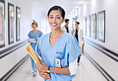 Smiling nurse in hospital corridor