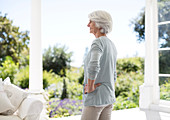 Senior woman standing on patio