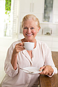 Portrait of senior woman drinking coffee