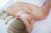 Woman laying on massage table at spa
