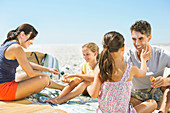 Family relaxing on beach