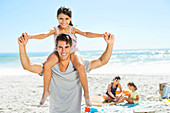 Father carrying daughter on shoulders