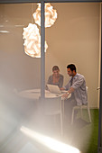 Business people using laptop at table