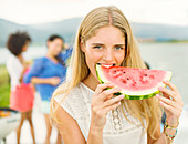 Portrait of woman eating watermelon