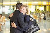 Business people hugging in office