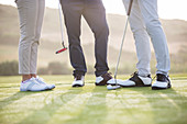 Friends standing on golf course