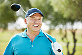Senior man holding golf club