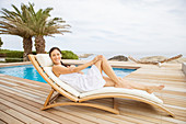 Woman relaxing in lounge chair