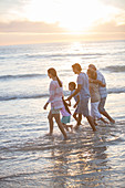 Family walking in surf at beach