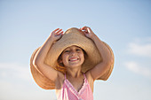 Girl wearing sun hat outdoors