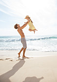 Father and daughter playing on beach