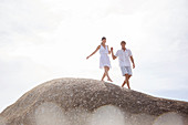 Couple walking on rock formation