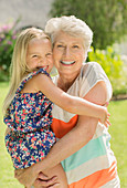 Older woman holding granddaughter