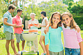 Girls hugging at backyard barbecue