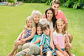 Family smiling together in backyard