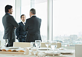 Businessmen talking in restaurant