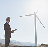 Businessman admiring wind turbine