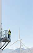 Worker standing on wind turbine