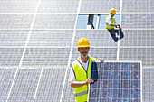 Worker holding solar panel