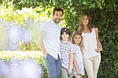 Family smiling under ivy