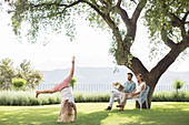 Couple watching daughter do cartwheel