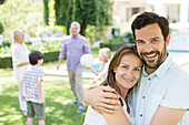 Couple hugging in backyard