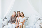 Multi-generation women smiling on daybed