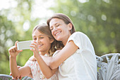 Mother and daughter using cell phone