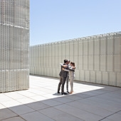 Business people hugging outdoors