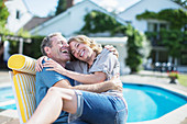 Couple relaxing in lounge chair side