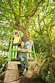 Father and children playing in treehouse