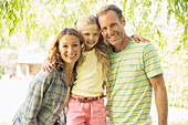 Family smiling together outdoors