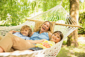 Mother and children relaxing in hammock