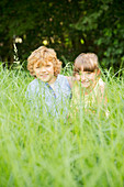 Children playing in tall grass