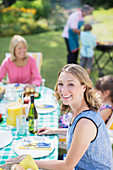 Woman smiling at table in backyard
