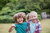 Smiling children hugging outdoors