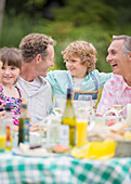 Family enjoying lunch at table outdoors