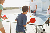 Family playing table tennis together