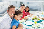 Family eating lunch at table on patio