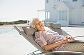 Senior woman sleeping on lounge chair