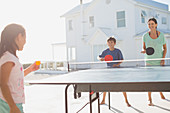 Family playing table tennis together