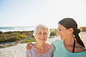 Mother and daughter on sunny beach