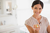 Woman holding handful of pills