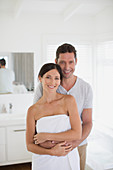 Couple hugging in bathroom