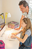 Father and daughter using computer