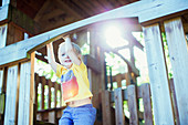 Boy playing on play structure outdoors