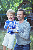 Father carrying son outdoors