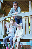 Father and children playing on playset