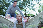 Father and children laying in hammock