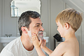 Boy rubbing shaving cream